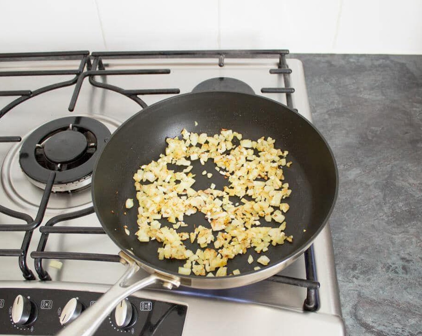 step 3 When the pan is hot, add in the Olive Oil (1 Tbsp) and the Onion (1). Fry for a few minutes until softened and starting to turn golden. Then add in the Garlic (2 cloves) and continue cooking, stirring constantly, for 1-2 minutes.