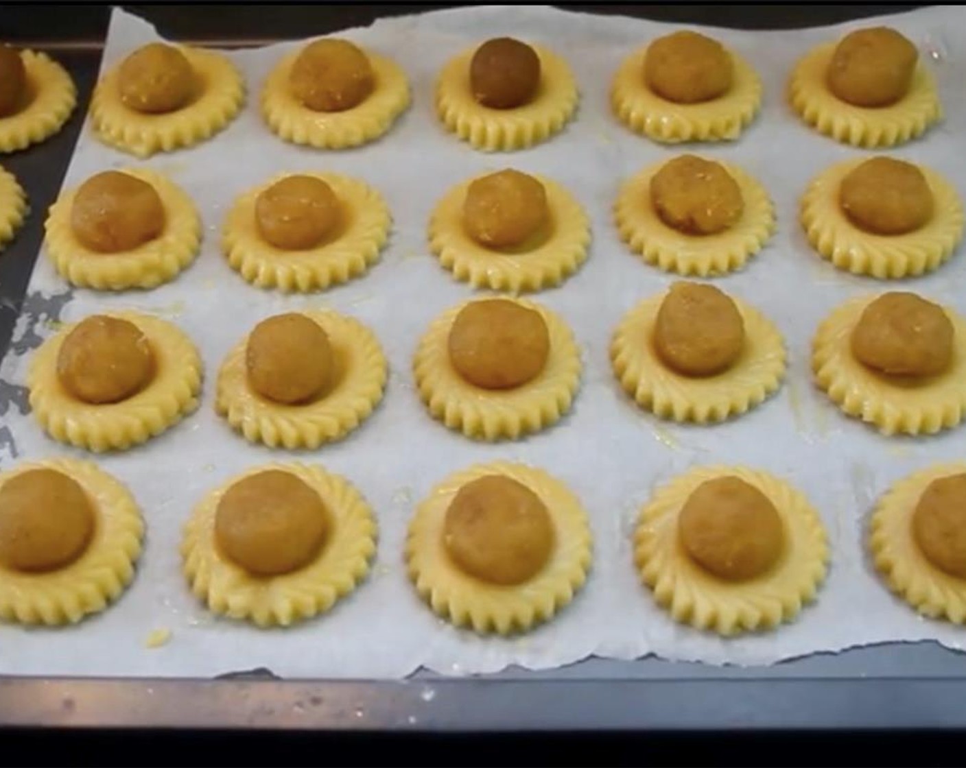 step 11 Combine Egg (1) and Water (1 Tbsp) to make egg wash. Brush the mixture onto each cookie. Top each cookie with a ball of pineapple filling. Let sit in the fridge while you preheat the oven to 170 degrees C (340 degrees F).