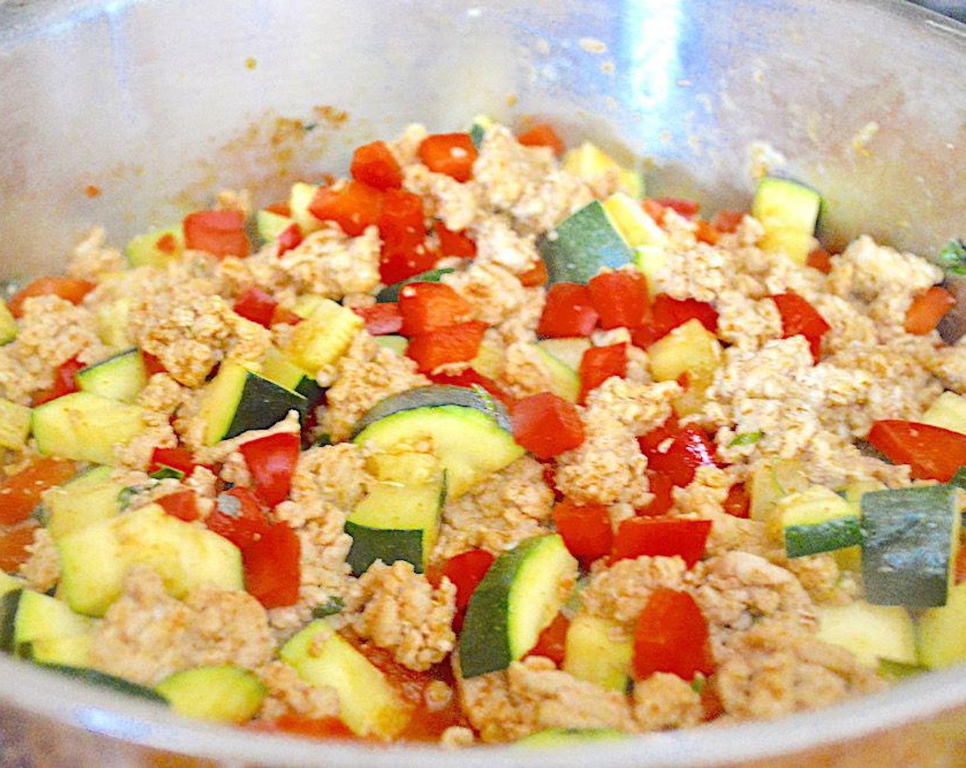 step 3 Meanwhile, make the filling. Heat more Olive Oil (as needed) in a large skillet over medium-high heat. Add in the Ground Chicken (1 lb) and break it up as you cook it through. Once it is pretty cooked through, add the Red Bell Pepper (1), Zucchini (1), Fresh Parsley (1 tsp), Low Sodium Taco Seasoning (2 Tbsp) and Lemon (1).