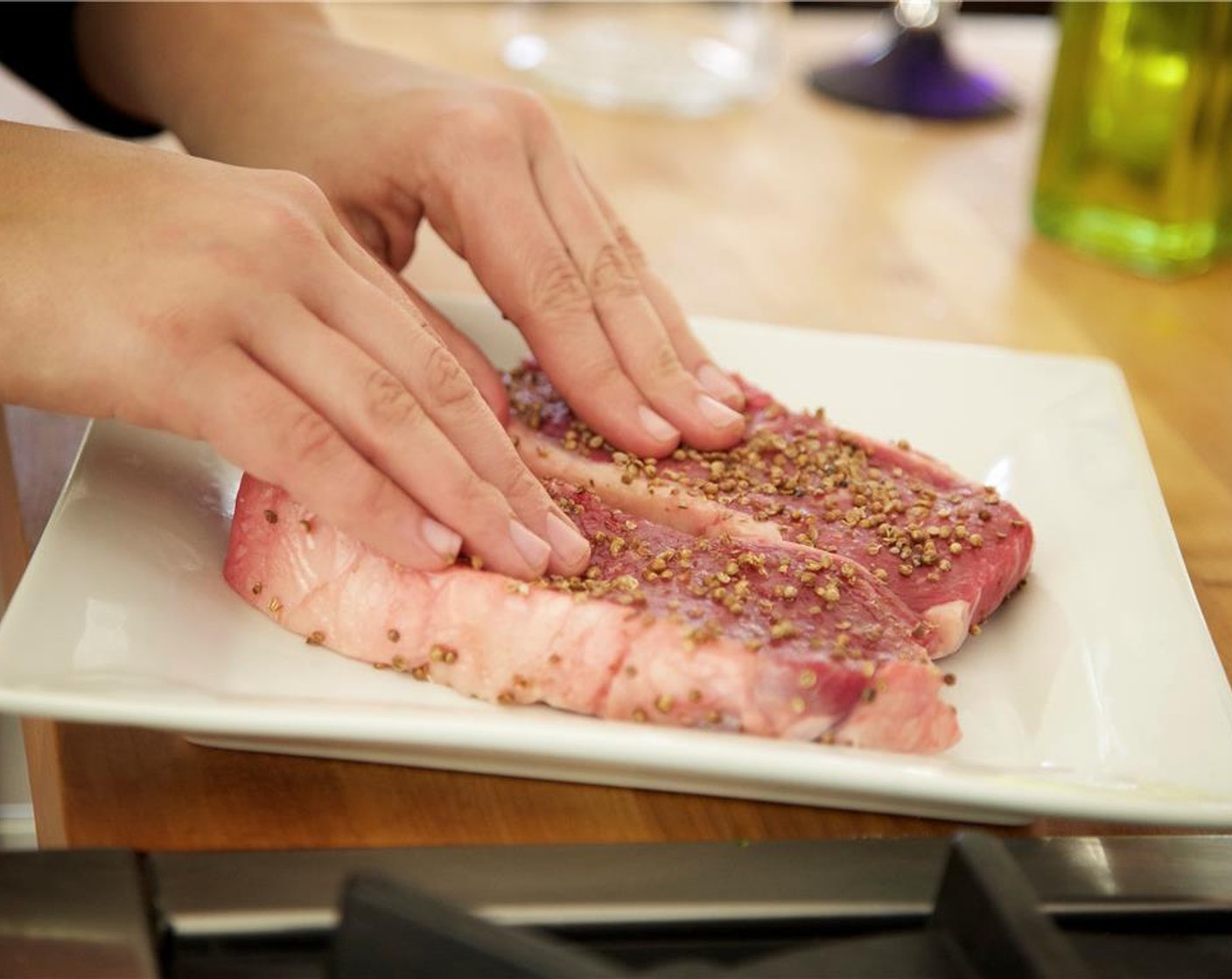 step 6 Meanwhile, pat dry the Boneless New York Strips (2) with paper towels. Rub 1/2 teaspoon olive oil onto each. Add the Kosher Salt (1 tsp) to the crushed coriander and stir until combined. Press the steak firmly into the mixture to ensure an even crust.