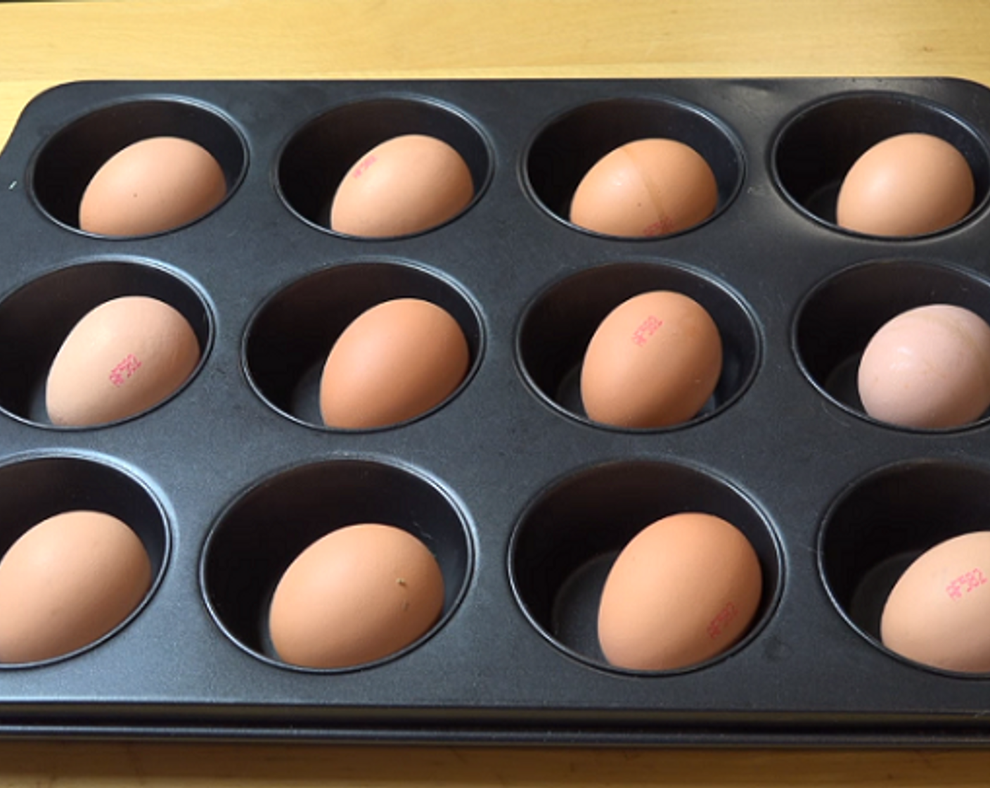 step 2 Then, in a 12-cup muffin tin, place an egg in each cup. Cook at 160 degrees C (325 degrees F) for 30 minutes. Let eggs cool completely before shelling.