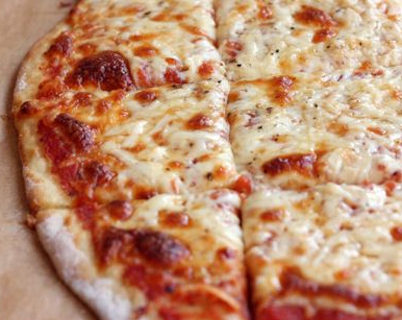 step 7 Slide the oven rack with the pizza stone out of the oven, and gently transfer the pizza to the stone before sliding the rack back inside. Bake for 12-15 minutes, until the edges of the crust are browning and the cheese is bubbly and brown.