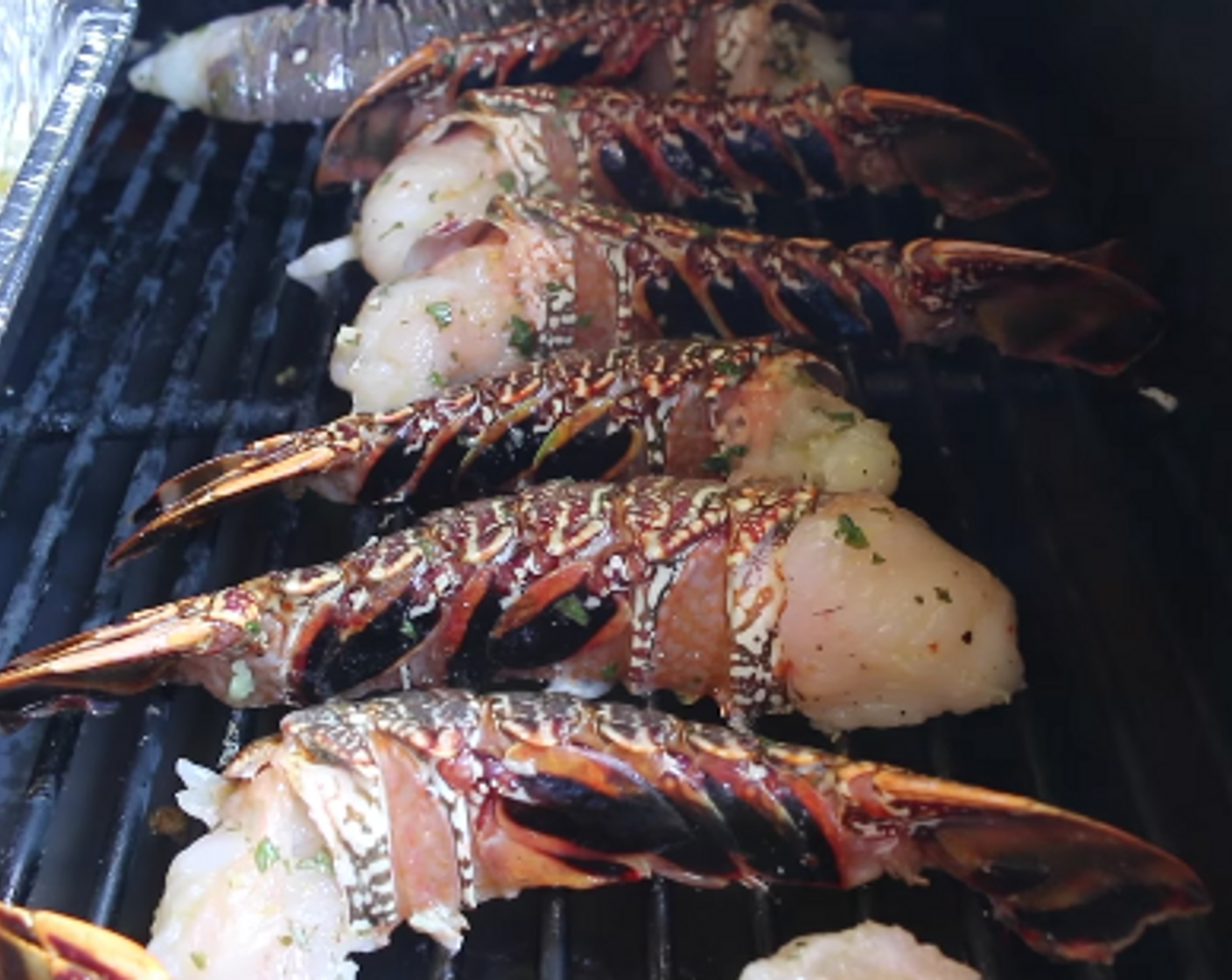 step 5 Place lobster tails meat side down on indirect side of grill and cook for 5-6 minutes. Baste the shell side with the butter mixture.