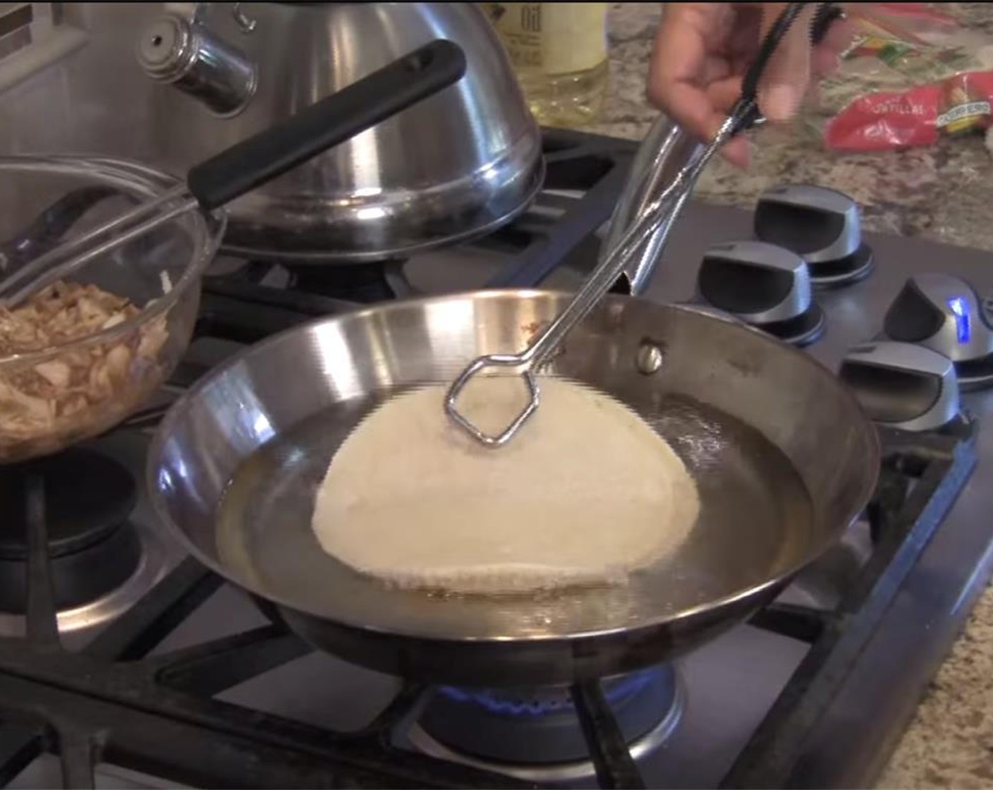 step 9 Dip your White Corn Tortillas (16) in the oil, two at a time, for just a few seconds. You don't want them to get hard, or they will be difficult to roll. Place on a foil covered cookie sheet, and spread out tortillas. Let cool 1 minute.