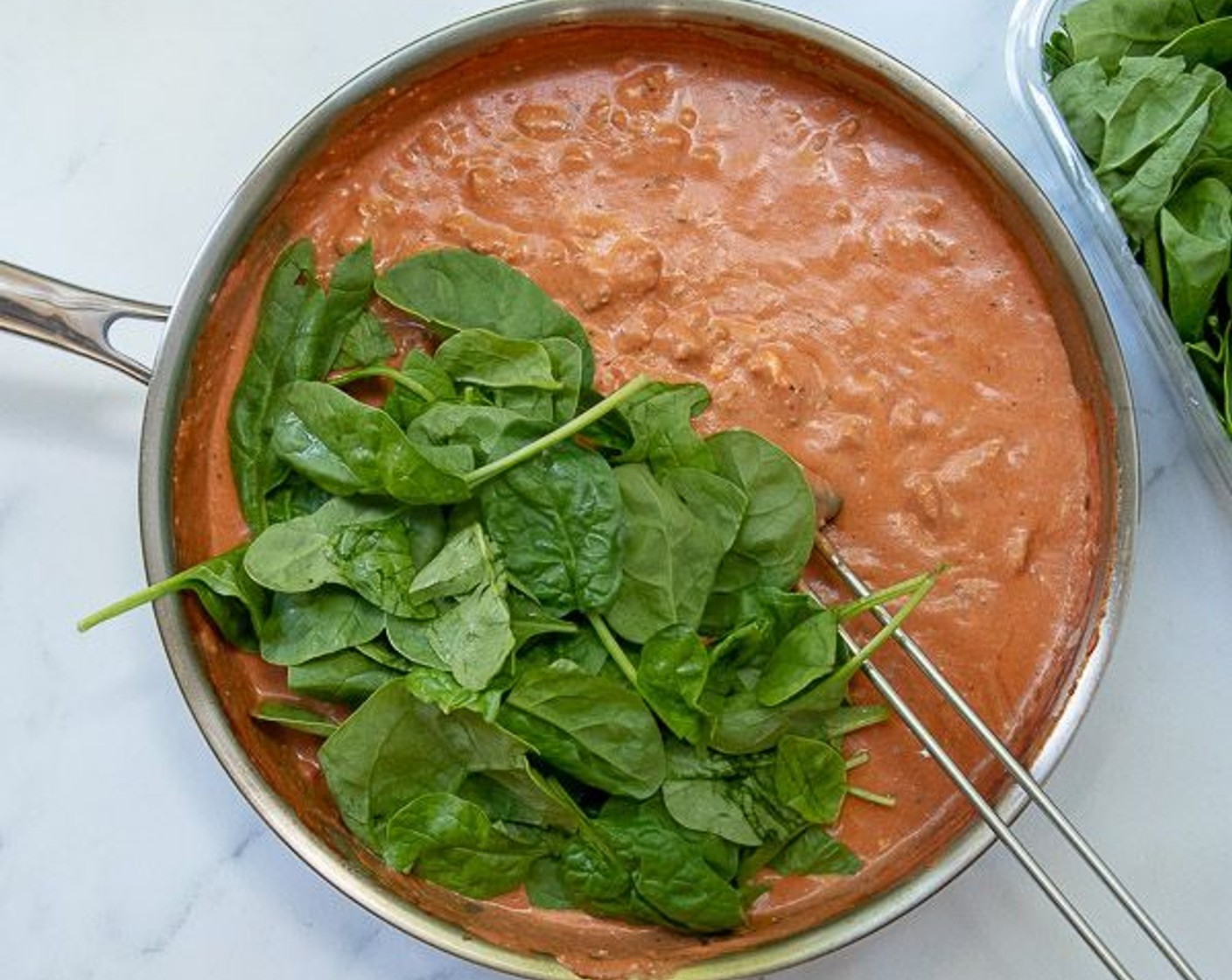 step 3 Reduce heat to medium and add Marinara Sauce (1 jar), scraping up browned bits on the bottom of the pan. Add Philadelphia Original Soft Cheese (1 cup) and stir until melted. Add Fresh Baby Spinach (4 3/4 cups), handfuls at a time, and stir until wilted.
