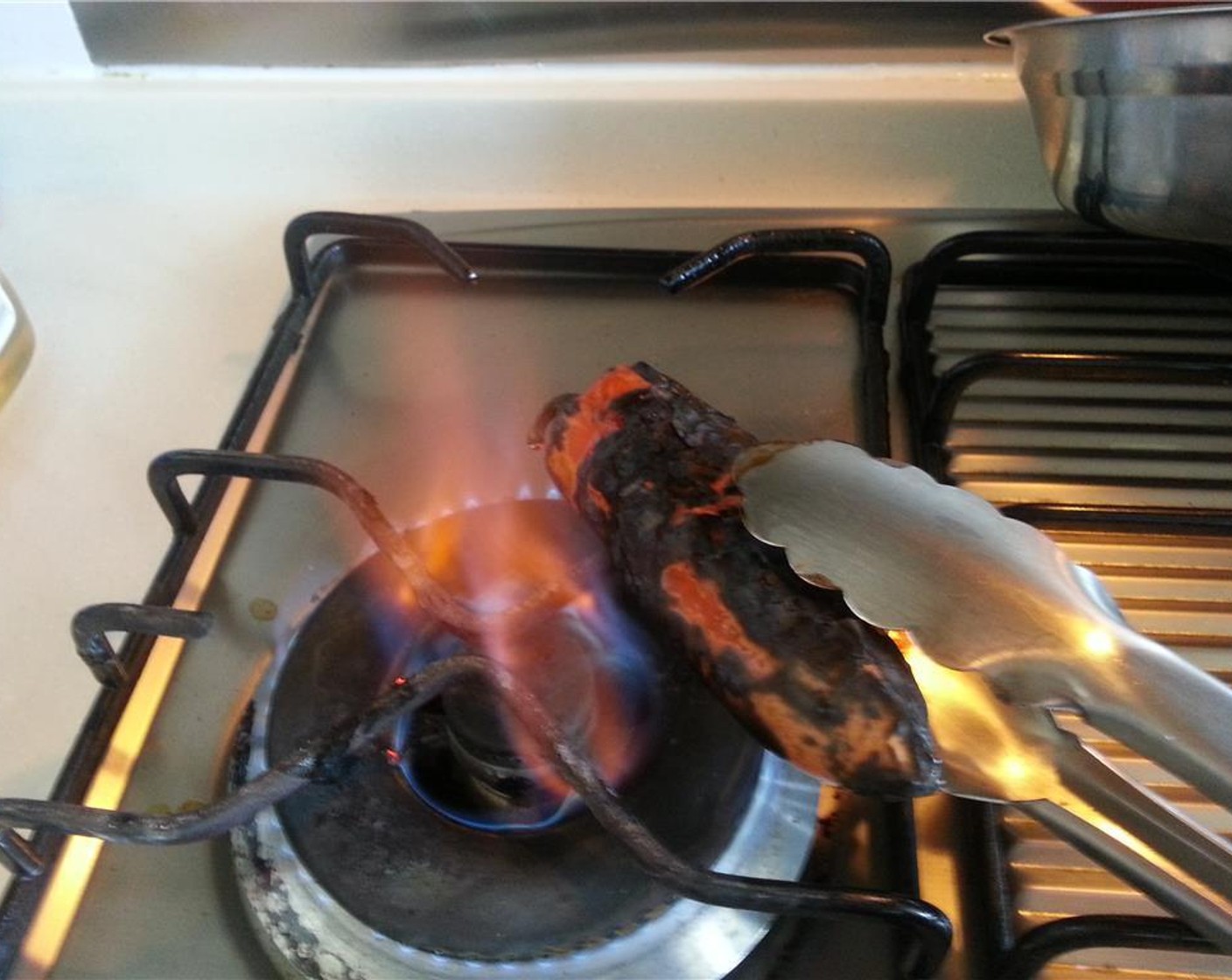 step 1 Begin by using your burner to char off the outside of the Pimiento Peppers (3) Make sure to get them properly charred, so the skin comes off easily after.