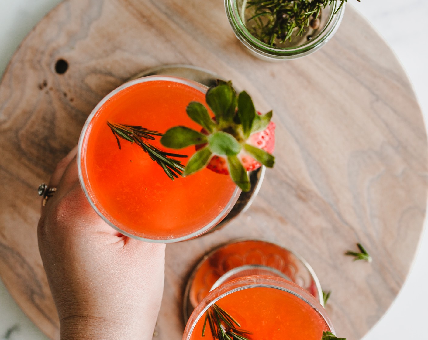 step 6 Strain into your chilled coupe glass and garnish with Fresh Rosemary (1 sprig) and one strawberry.