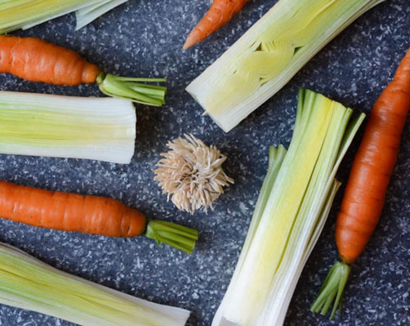 step 2 Slice Leeks (3) in half lengthwise and rinse any grit or sand out of them. Place the leeks and Carrots (6) in a casserole dish.