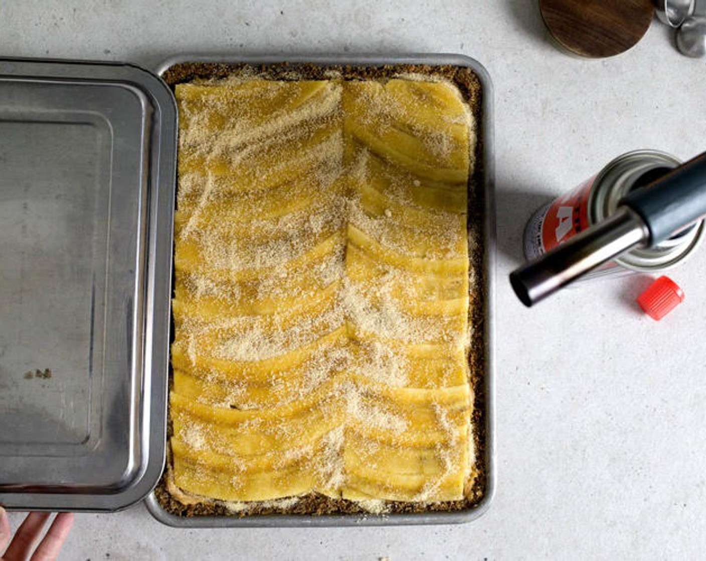 step 13 Evenly spread the Brown Sugar (1/2 cup) on top of the bananas. Hold another pan to cover/protect the crust-part of the pie from the torch, then with the other hand, torch the sugar until deeply caramelized.