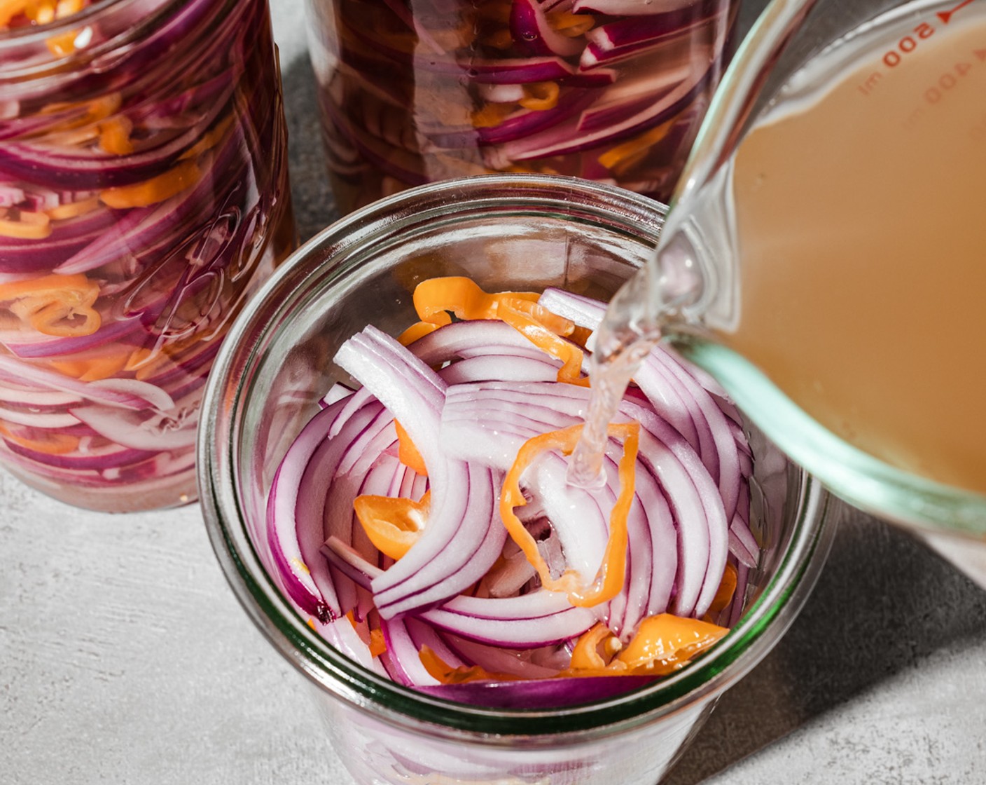 step 4 Pour the brine over the prepared onions and peppers, leaving about 1/2-inch headspace at the top of the jar. Seal with a lid and allow the jar to cool down to room temperature before storing it in the refrigerator.