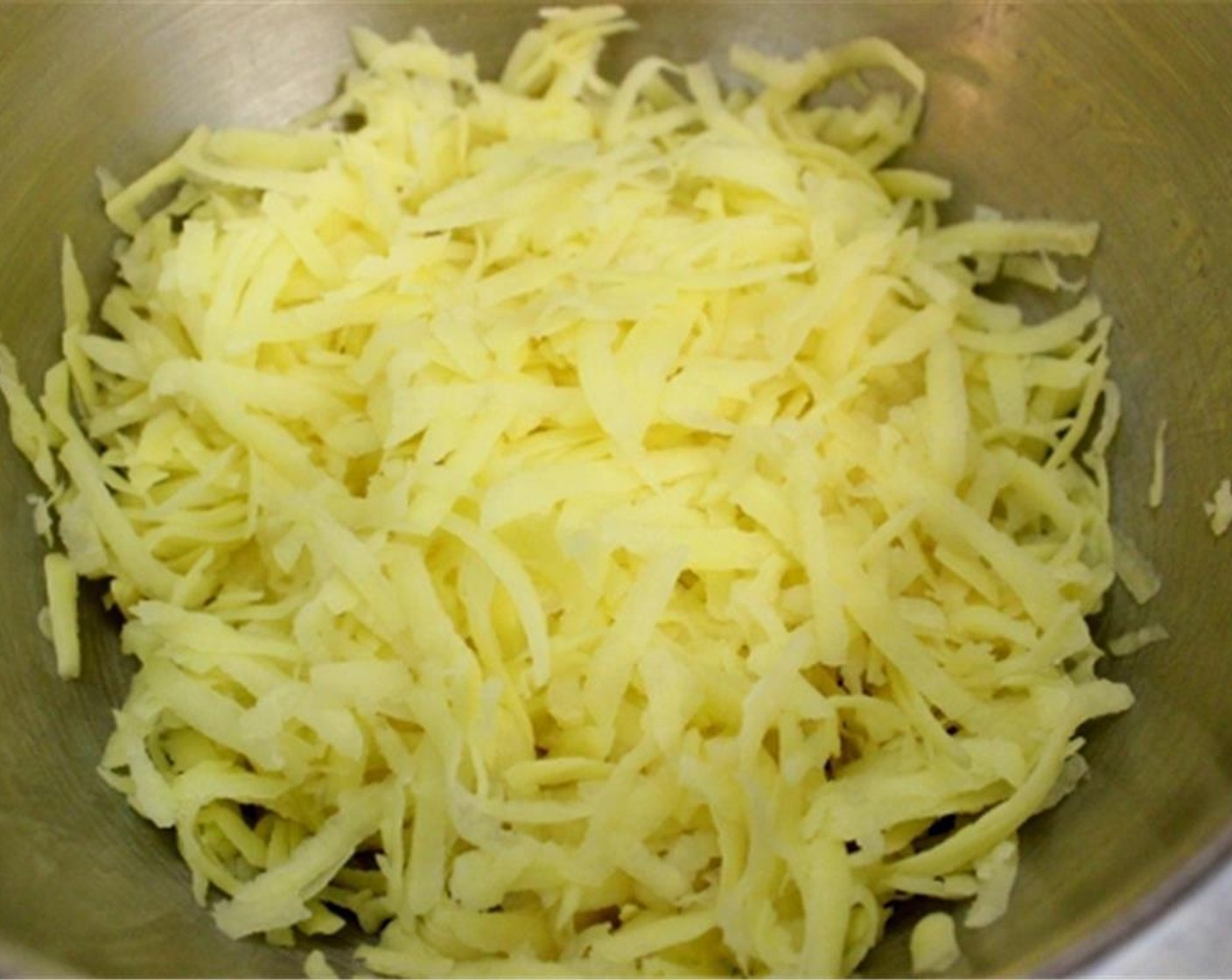 step 1 Peel the medium Yukon Gold Potatoes (4 1/2 cups) and grate on a box grater. Remove all excess moisture by squeezing the potatoes through a cheese cloth or kitchen towel.