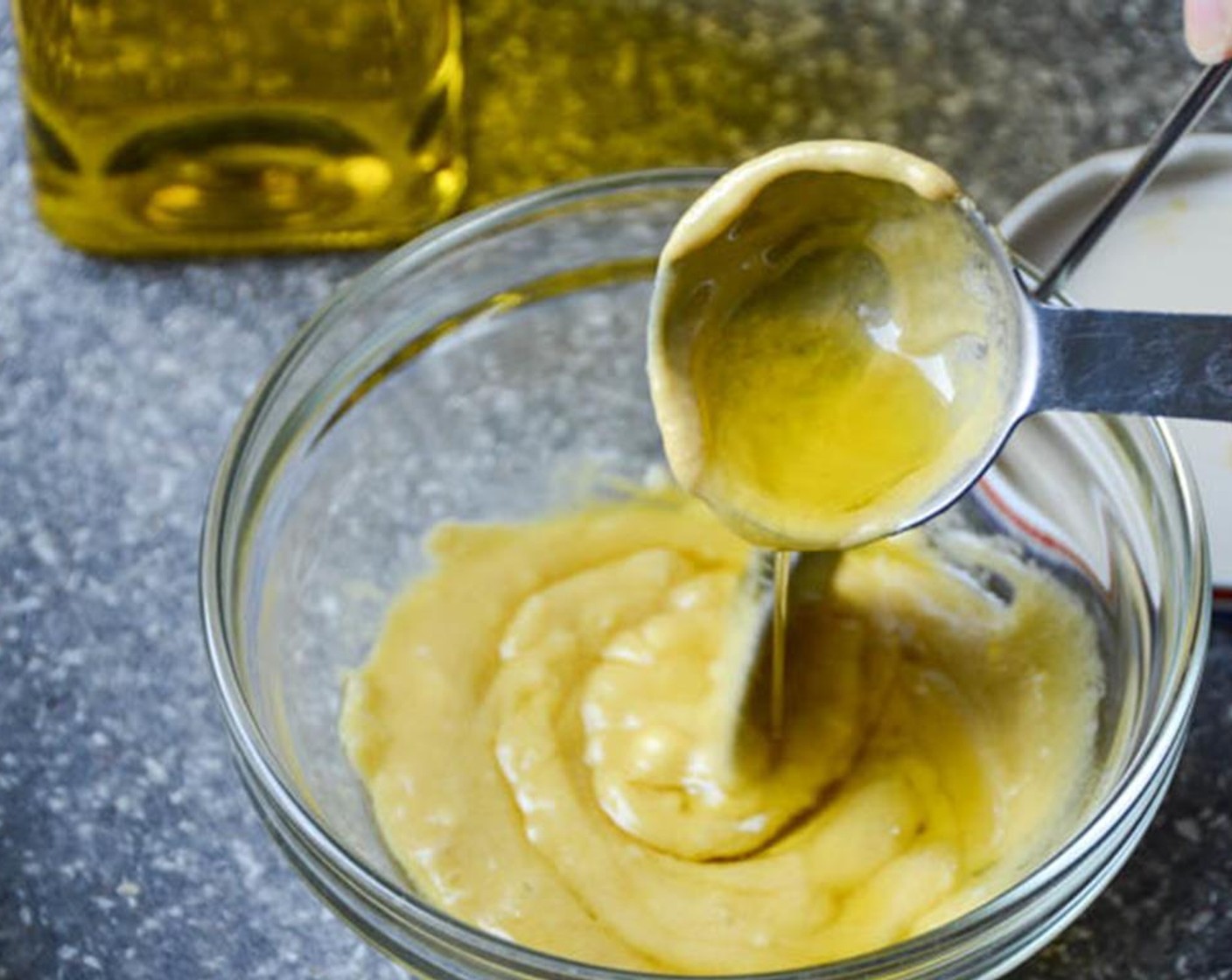 step 4 Slowly drizzle the Olive Oil (2 1/2 Tbsp) into the mustard mix  while stirring to emulsify. Add the freshly Ground Black Pepper (to taste) and stir to combine. Set aside.