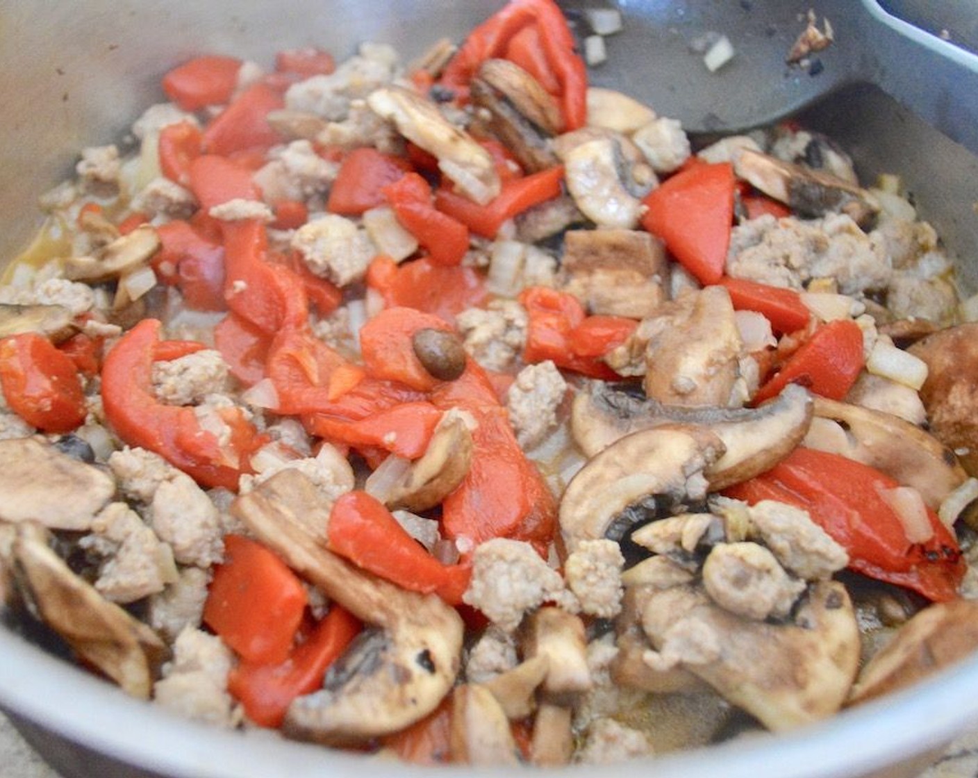step 5 Once sausage is mostly cooked, add the Jarred Roasted Red Peppers (1 jar), Cremini Mushrooms (2 1/4 cups), and Onion (1). Let them cook with the sausage until soft and fragrant, just a few minutes. Take the mixture off the heat and let it cool.