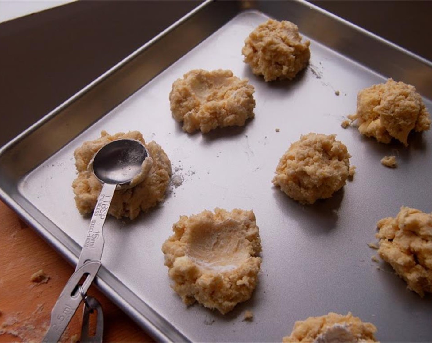 step 6 Dip a tablespoon measure in flour to coat, then press it onto the center of the scone to form a deep well for the jam. At this point, freeze the dough for at least 2 hours.