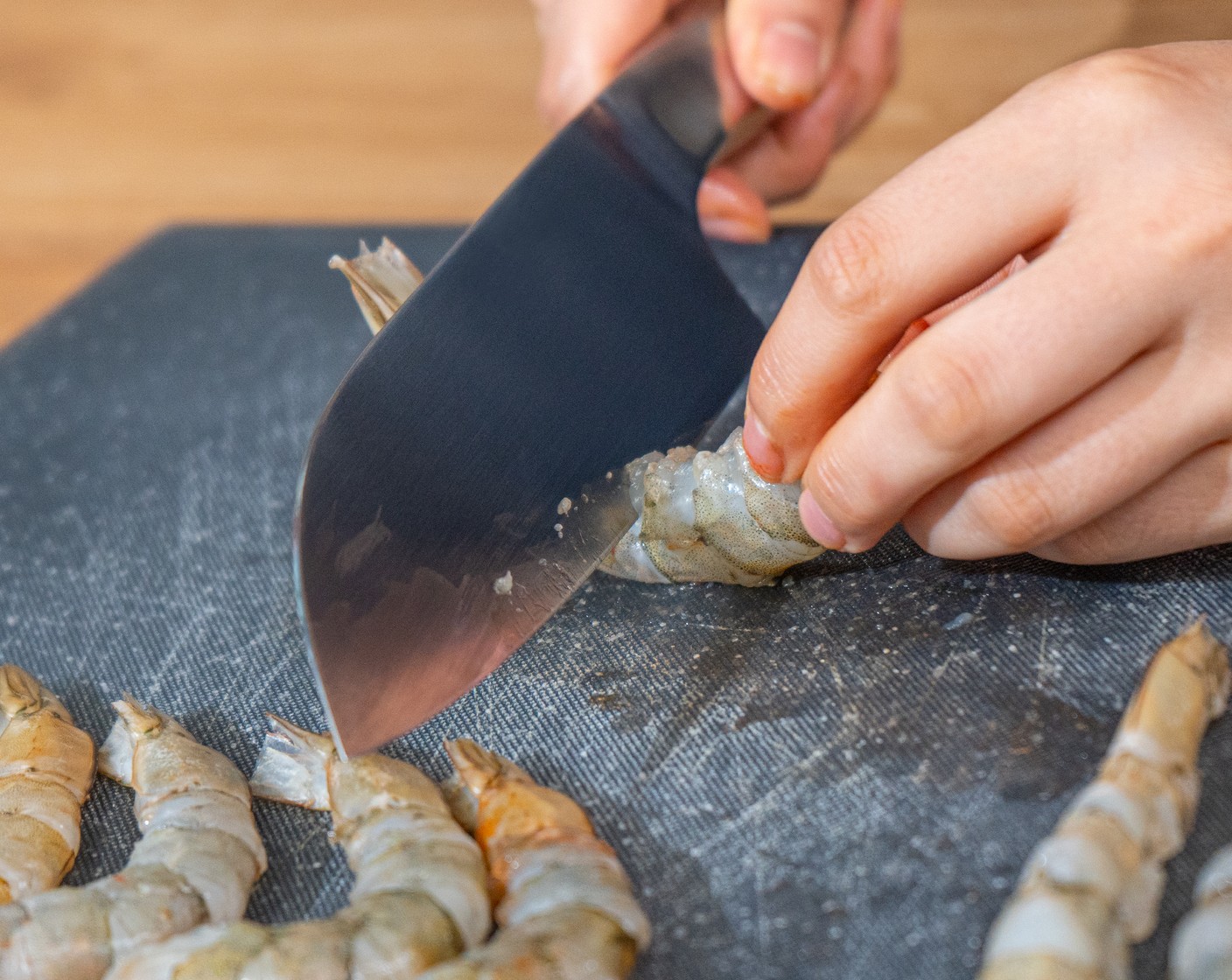 step 5 Make 4-5 slits underside of the prawns. Flip the prawns back and press down to straighten the body. This is to prevent the prawns from curling up when frying. Place the prawns onto a clean tray.