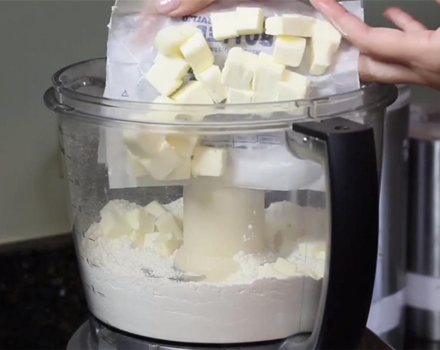 step 3 Add the cubed butter into the food processor. Pulse some more, until the butter is in pea-sized pieces.