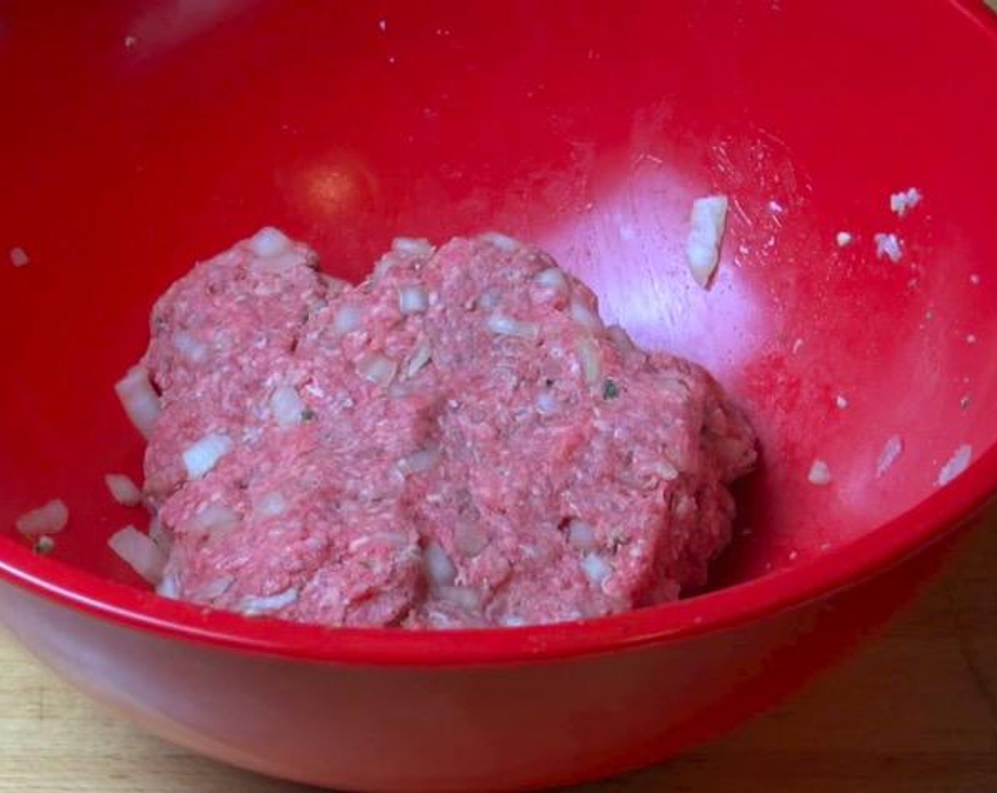 step 1 In a large mixing bowl, add Ground Beef (1.1 lb), Yellow Onion (1), Garlic (1 clove), Dried Mixed Herbs (1 Tbsp), Ketchup (1 Tbsp), Salt (to taste), and Ground Black Pepper (to taste). Using your hands, mix together until combined.