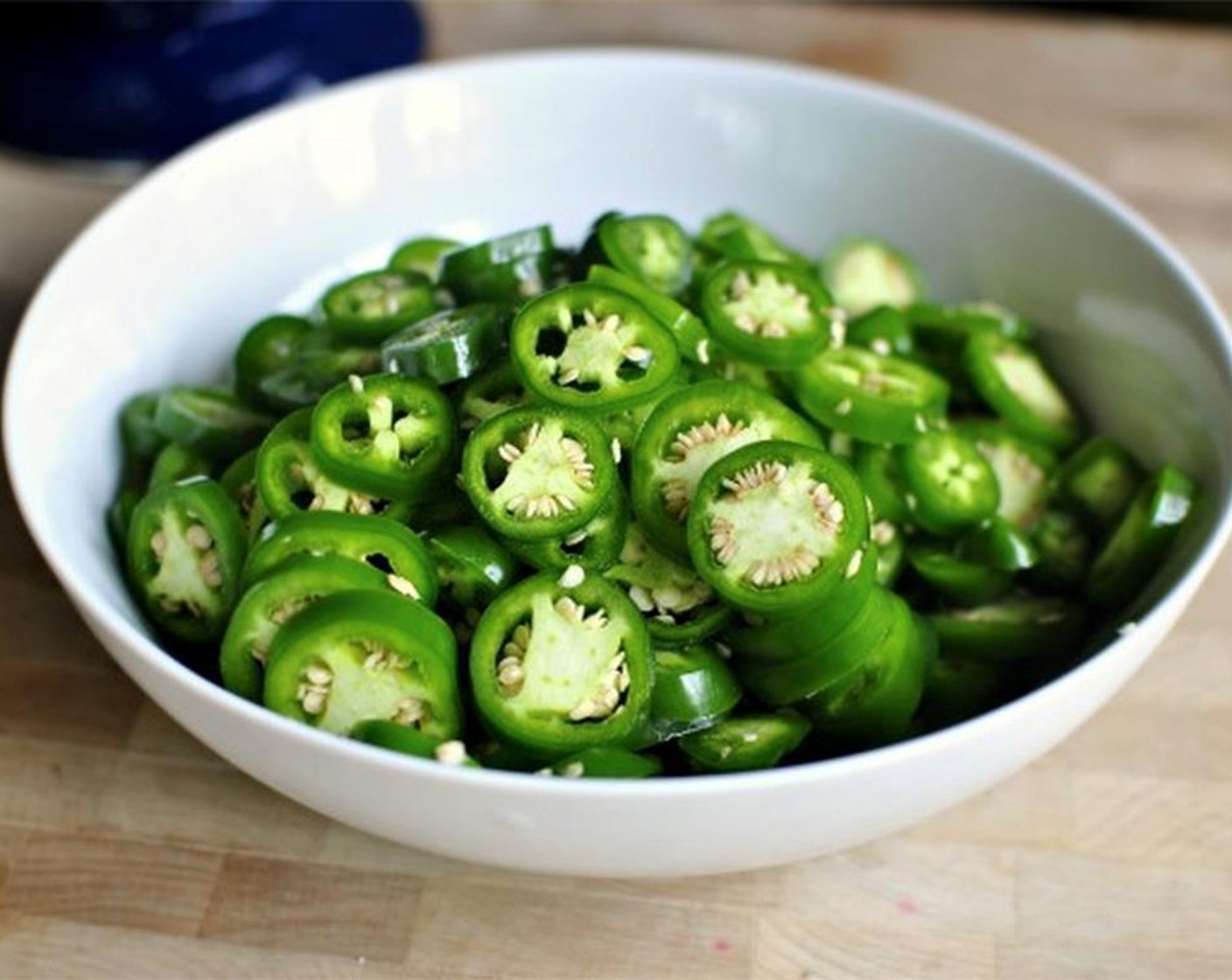 step 1 Slice the Jalapeño Peppers (3) into thin rings about an 1/8-inch thick. Rinse seeds out of the jalapenos under cold water. Do not use warm or hot water. Reserve in cold water until later.