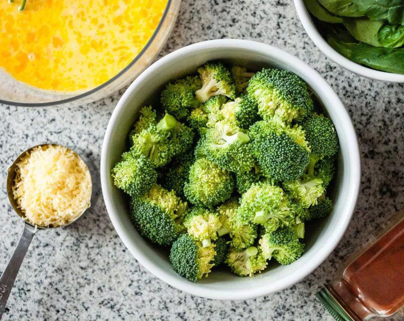 step 3 Heat cast iron skillet (or other oven-proof skillet) over medium heat. Add Olive Oil (1 Tbsp), once warm, add Garlic (4 cloves) and Onion (1/4) and sauté for 5 minutes. Add Broccoli (3 heads), sauté another 5 minutes.