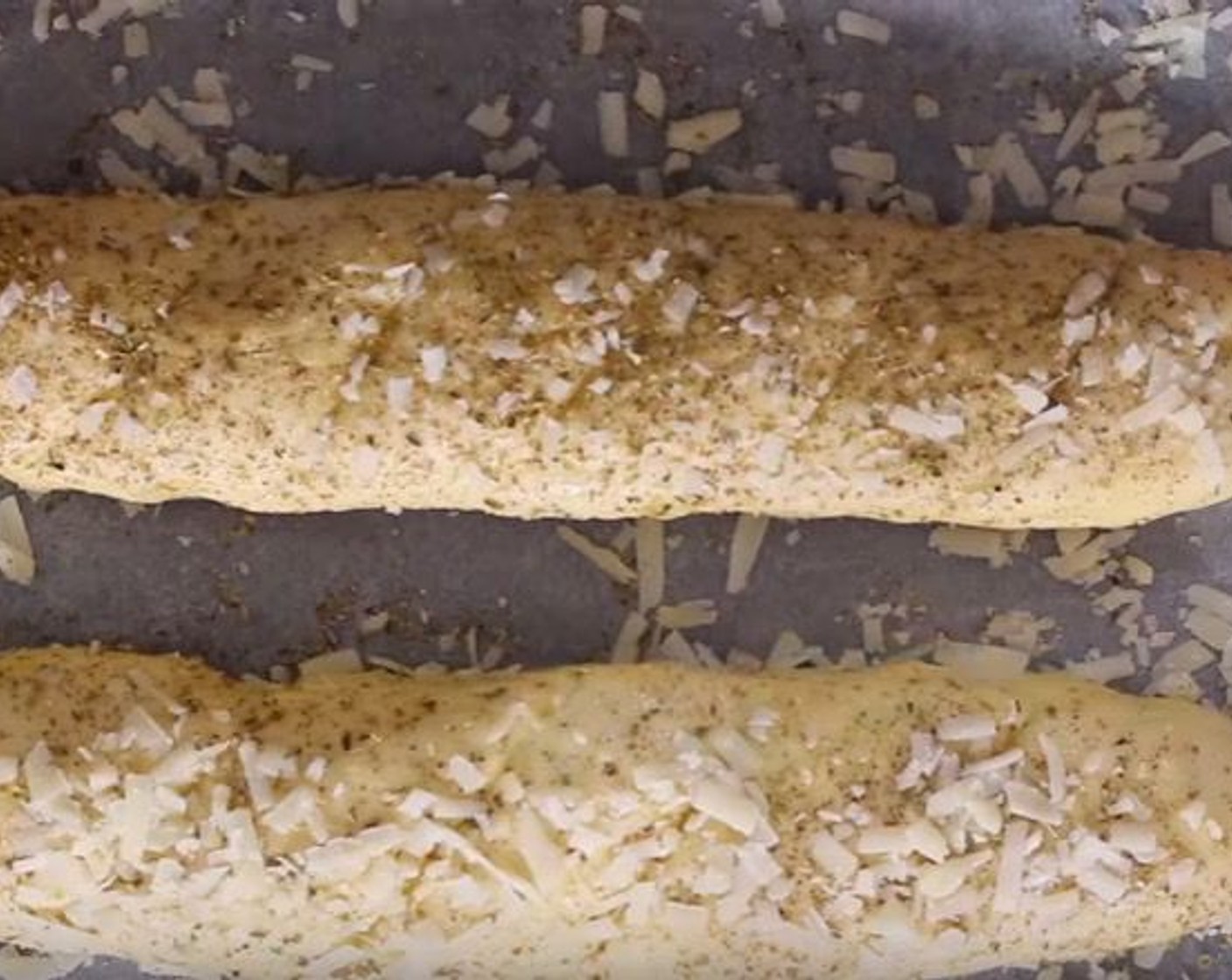 step 10 Sprinkle over Dried Oregano (to taste) and Grated Parmesan Cheese (to taste). Turn the loaves to coat both sides.