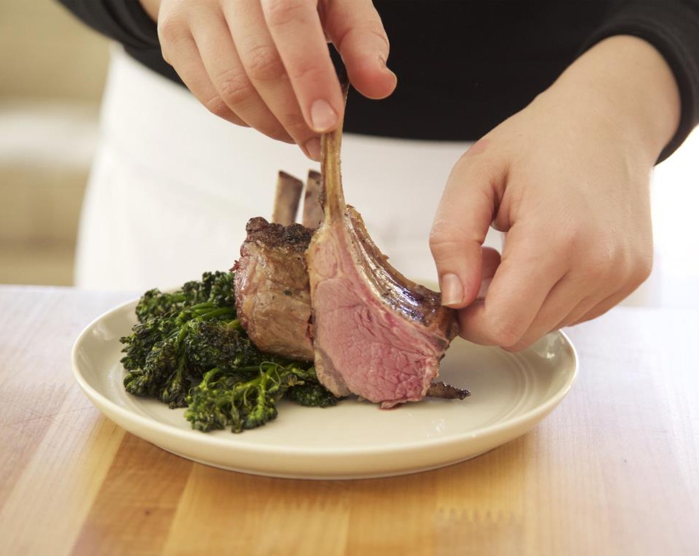 step 16 Divide the broccolini equally between two plates. Arrange the lamb chops on top of the broccolini. Spoon the gastrique over the lamb. Serve and enjoy!