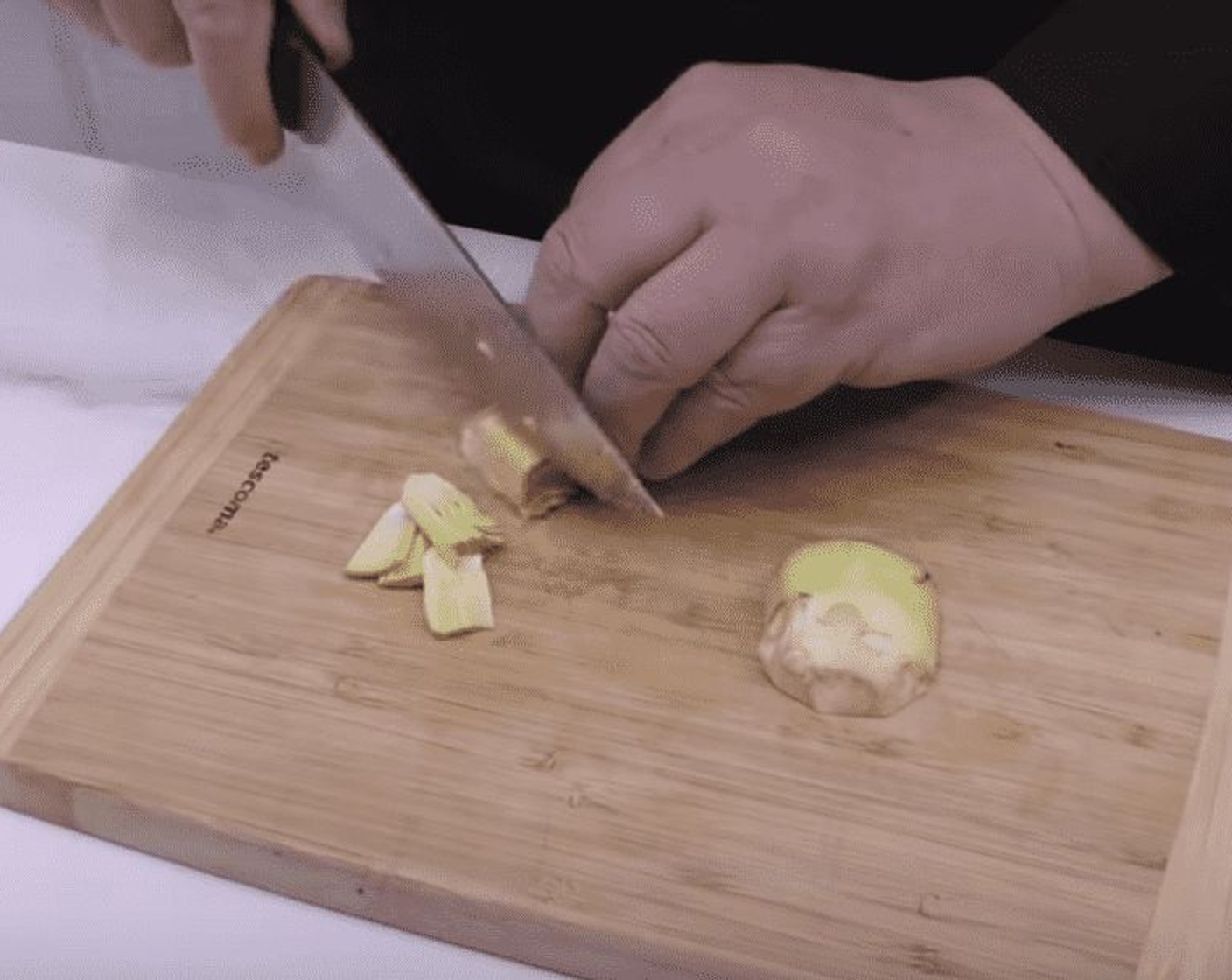 step 2 Cut the artichoke centers in half an slice thinly.