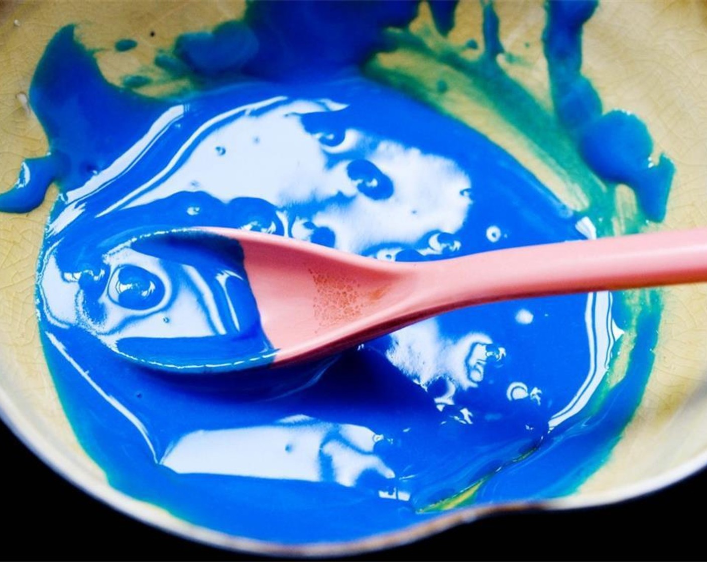 step 7 Divide the icing into 3 bowls, leave one white and add Blue Food Coloring (to taste) to one of the other bowls.