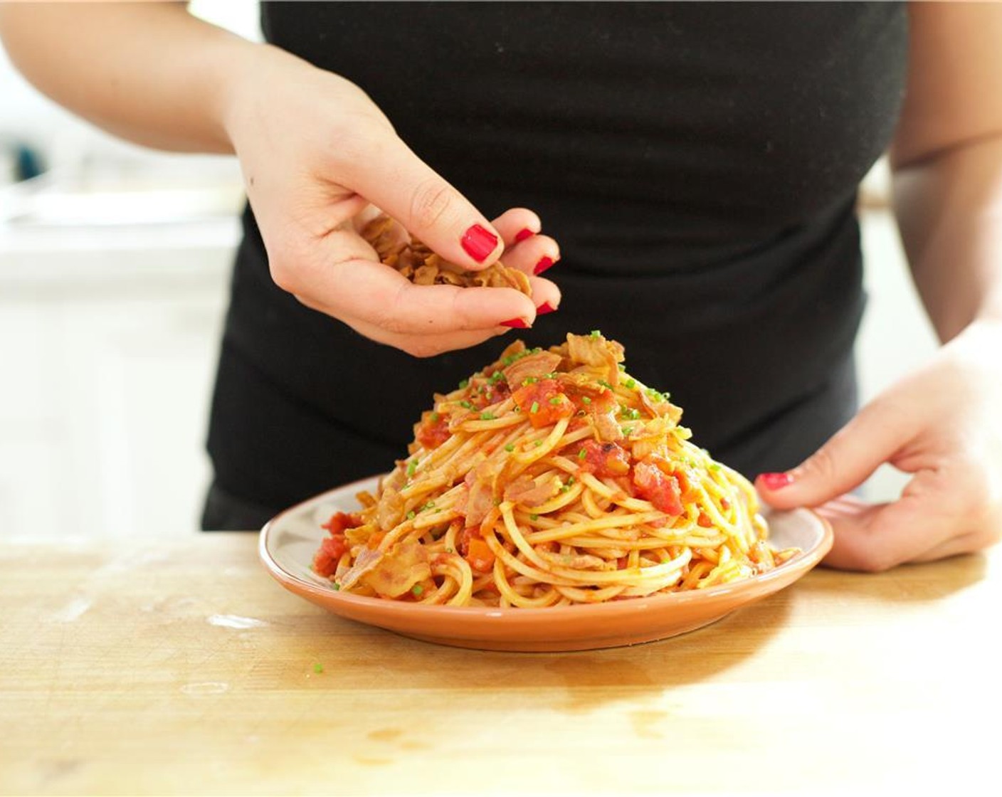 step 15 Place the Spaghetti Alla Chitarra (8 oz) into the center of two plates. Top with remaining parmesan cheese (1/2 cup) and the chives.