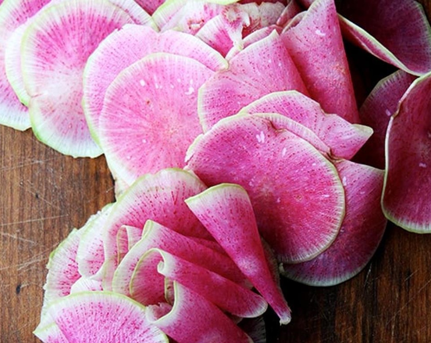 step 2 Cut off one end of the Watermelon Radishes (2). Leave the other intact so you have a handle when you run the radish down your mandoline. Peel the radishes if you wish, though it is by no means necessary. Thinly slice on a mandoline.