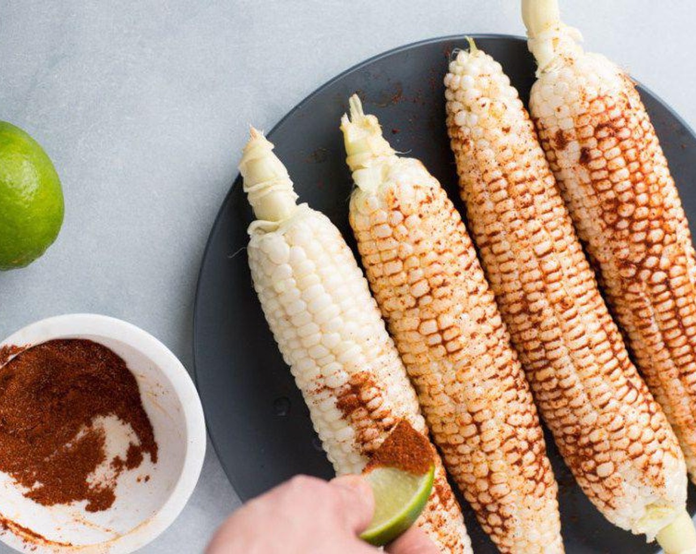 step 2 Use the Lime (1) to prepare the corn. Use two of the quarters to drizzle lime juice over the Sweet Corn (4 ears). Use the other two slices to brush the corn with the seasoning mix. Dip these lime wedges into the spice mix and brush the corn liberally like you would your teeth with toothpaste.