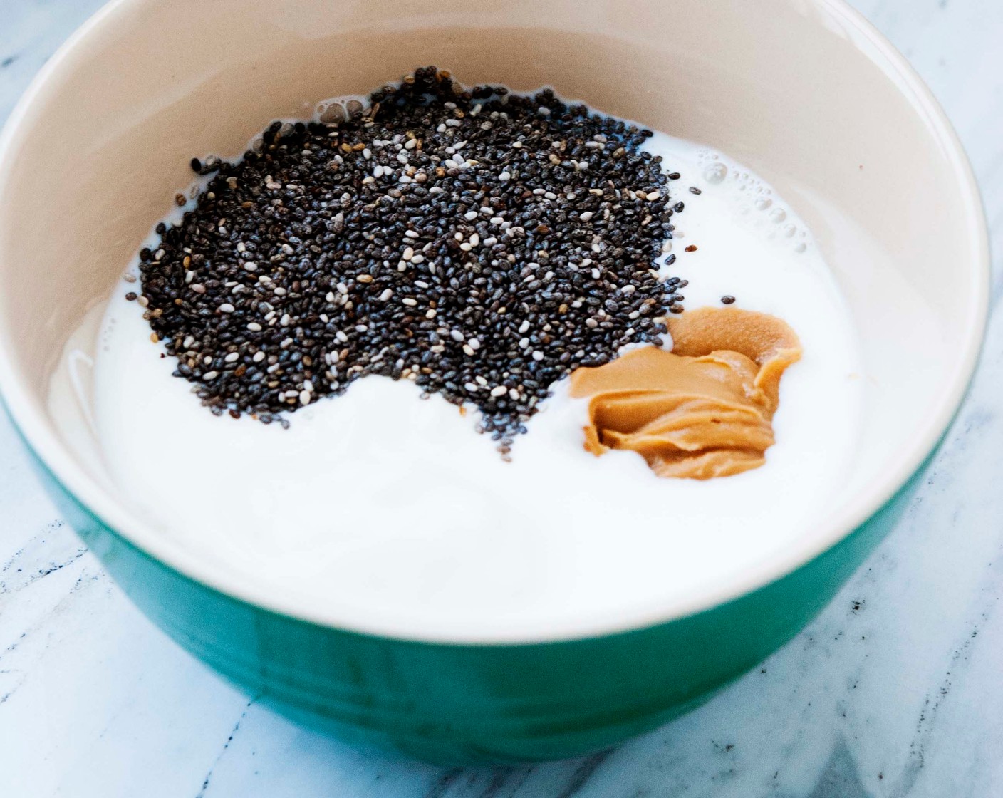 step 1 Place the Greek Yogurt (1/2 cup), Whole Milk (1/4 cup), Chia Seeds (1 Tbsp), and Creamy Peanut Butter (1 Tbsp) together into a large bowl and whisk until they are well combined. If it’s cold, it might take some time for the peanut butter to stir into the milk and yogurt.