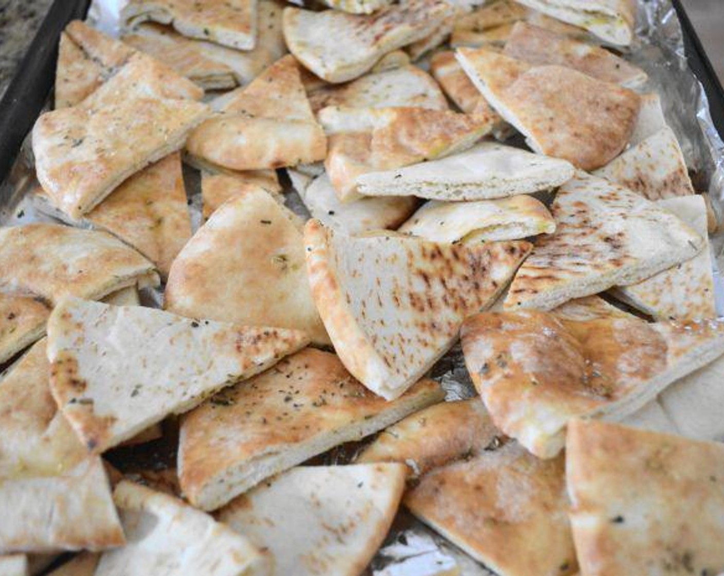 step 4 Add the zest and juice of a Lemon (1), Dried Oregano (2 pinches), Salt (2 pinches), and a generous drizzle of Olive Oil (as needed). Toss it all together well to make sure the chips are coated. Get them into the oven to crisp up for about 15 minutes. When they are done, take them out and set them aside.