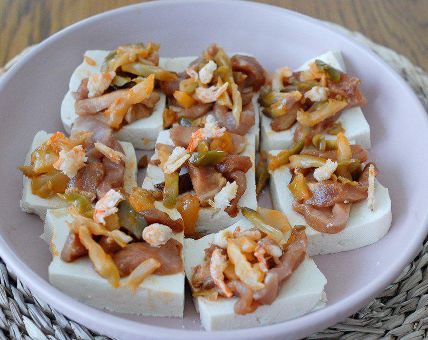 step 2 Cut the Tofu (1 pckg) into small pieces, put on the plate, then add meat, Hot Pickled Mustard (3 Tbsp) and Dried Shrimp (to taste) on top. Steam under medium heat for 15 minutes.