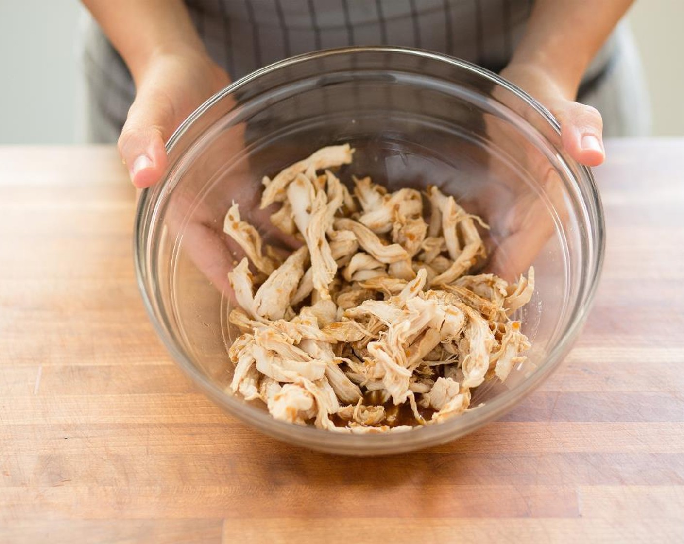 step 5 In a medium bowl, combine the shredded chicken with Teriyaki Sauce (1/4 cup) and toss to combine.
