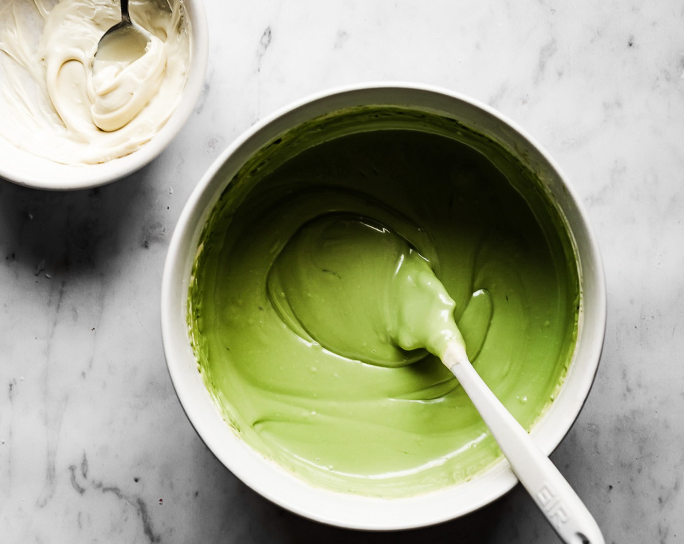step 6 Use a small sieve to sift the Matcha Powder (1/2 Tbsp) into the large bowl of melted white chocolate, stir well with a spatula until matcha is well combined with the white chocolate