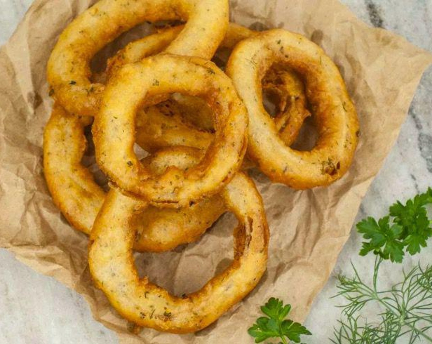 step 6 When oil is hot, scoop out 4-6 onion rings and dunk in batter to completely coat. Shake off excess batter and place onion rings in oil one at a time. Cook for approximately 2-3 minutes on each side, or until golden brown.