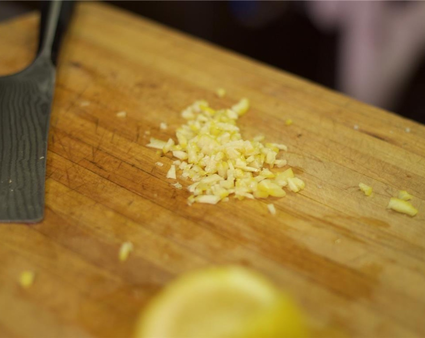 step 4 Hold the wedges skin side down on a cutting board. Run the blade of the knife over the lemon to remove all the pith and pulp, so there is no white at all. Mince the peel finely.