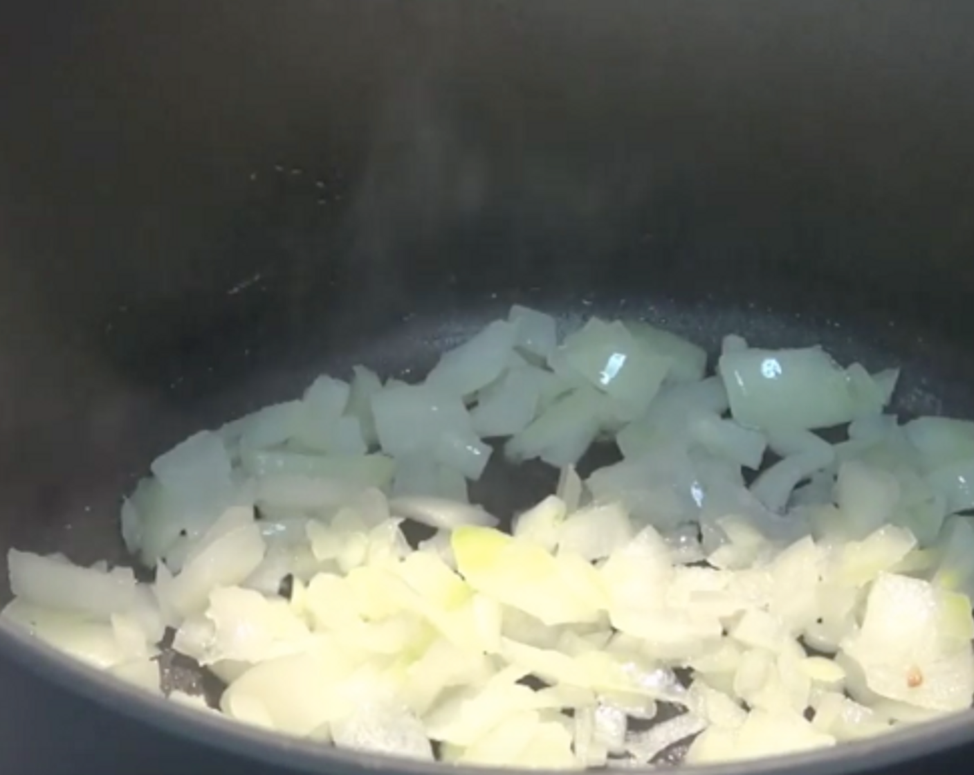 step 1 Get a saucepan with a little bit of Olive Oil (2 Tbsp) in it. Add in Yellow Onion (1) which has been roughly chopped up over a medium heat.