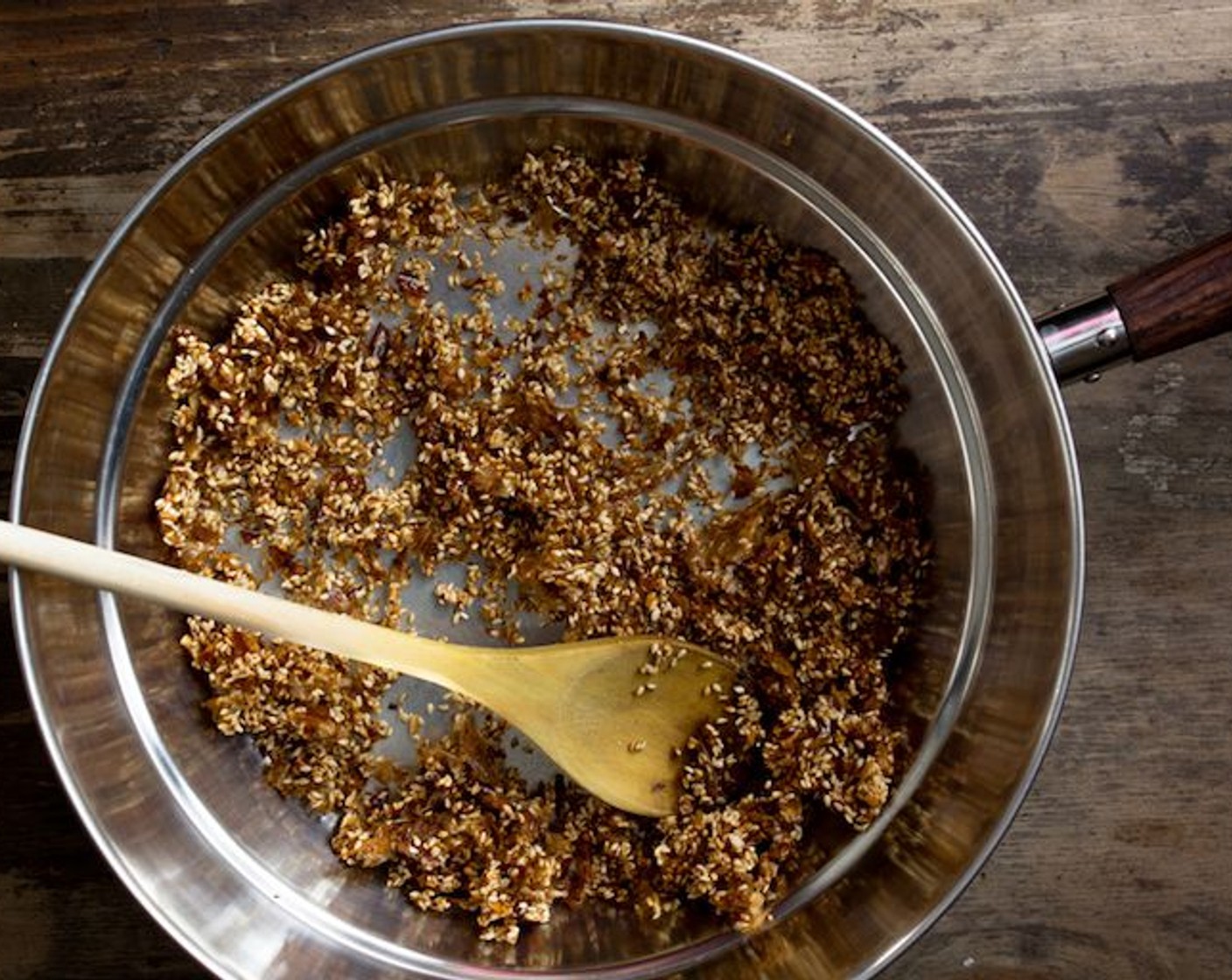 step 8 Add the Sesame Seeds (1/4 cup) and Garlic (2 cloves) and mix it together and toast it for another 4-6 minutes until they are ‘candied’. It should be golden brown colour, make sure to keep everything moving in the pan to prevent it from burning.