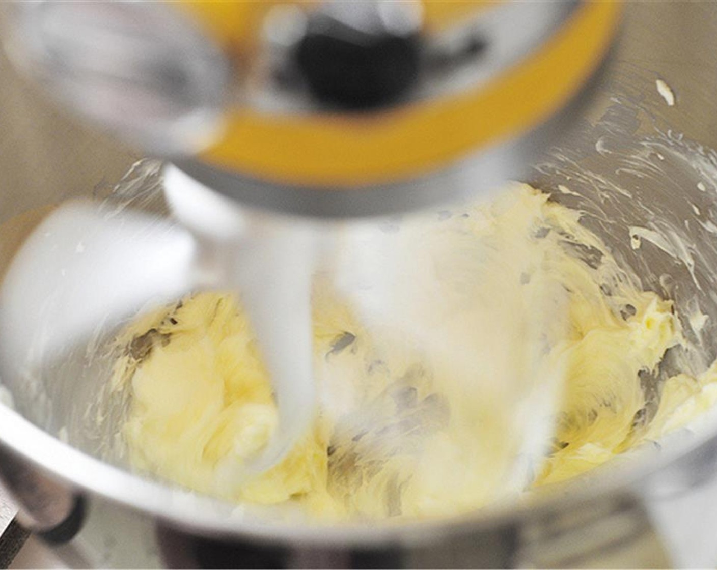 step 6 In the bowl of a mixer fitted with the paddle attachment, add the Unsalted Butter (1/2 cup). Whip for 3 minutes.