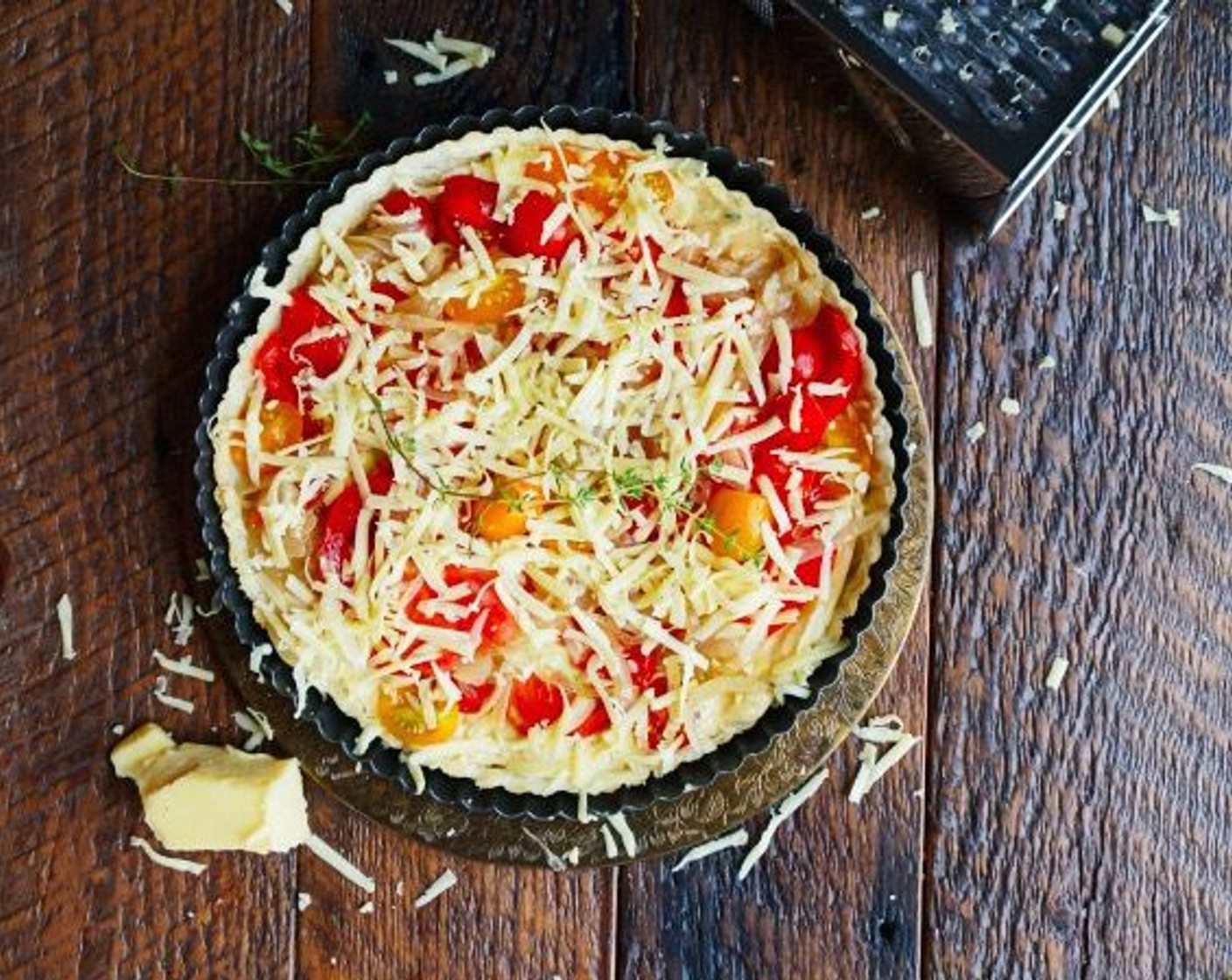 step 16 Top with onions and Beefsteak Tomato (1 cup), then sprinkle with remaining Gruyère Cheese (4 Tbsp). Cook until tart is hot and cheese is melted, 10-15 minutes.