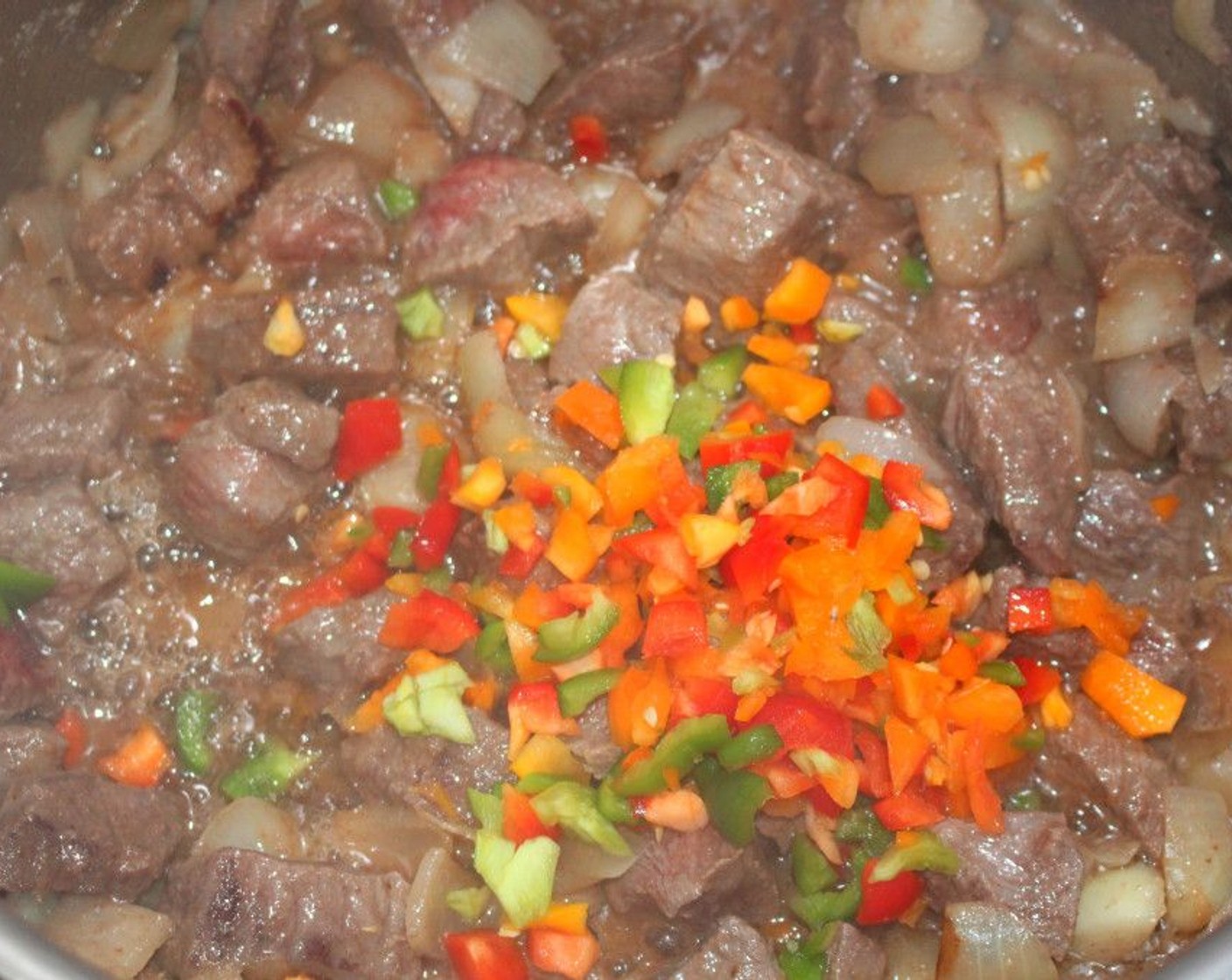 step 4 Add the 1 Tbsp of Garlic Confit, Red Bell Pepper (1/2), Green Bell Pepper (1/2), and Yellow Bell Pepper (1/2).