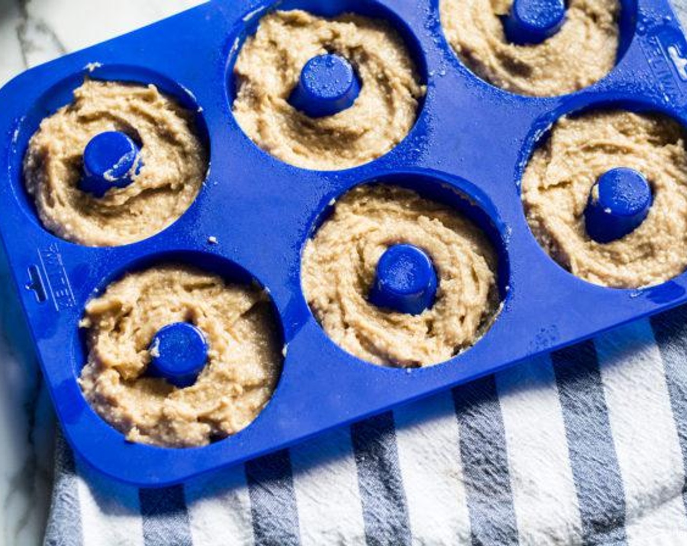 step 5 Spoon batter into each donut mould, filling approx ¾ of the way full.