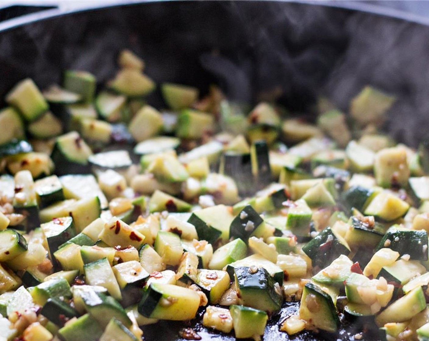 step 4 Let them sizzle for 30 seconds to a minute, then add the small finely diced Zucchini (2). Stir the vegetables to coat them. Cook for 5 to 7 minutes, stirring occasionally, until some of the water has cooked off and the veggies are tender when stabbed with a fork.