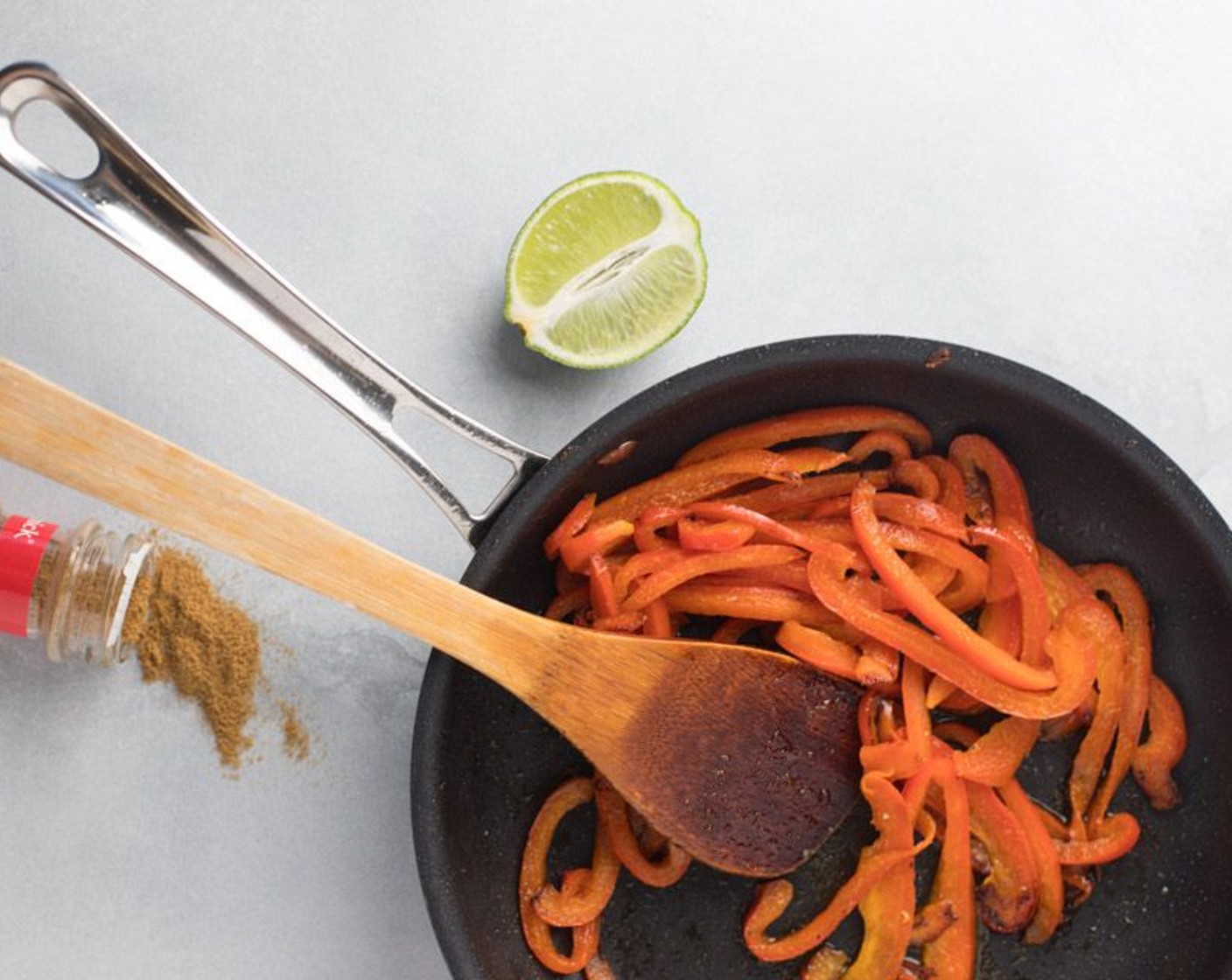 step 4 In an empty pan, fry in the remaining Olive Oil (1 Tbsp), the Red Bell Pepper (1) and Ground Cumin (2 tsp), over medium heat for 5 minutes. Add the juice of 1 Lime (1) at the end of frying.