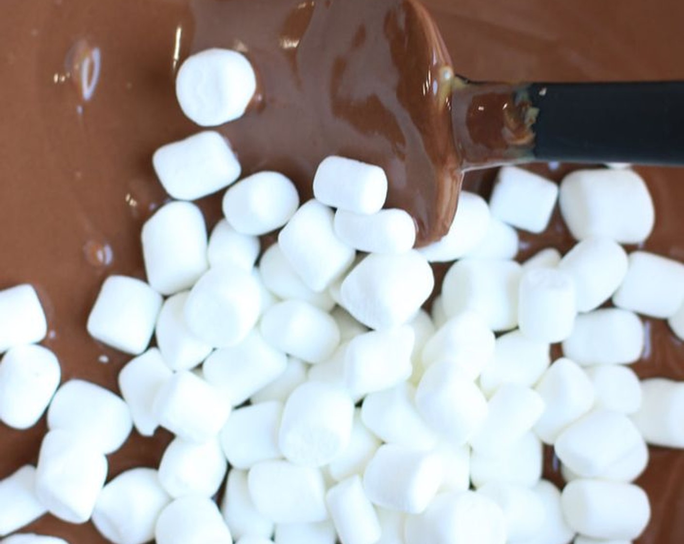 step 4 Stir in Mini Marshmallows (1 bag) and gently stir until marshmallows are evenly coated with the melted chocolate mixture.