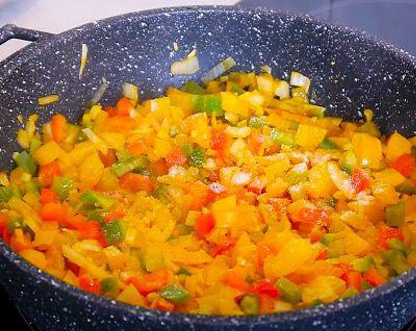 step 4 Once the oil is yellow add the Onion (1), Green Bell Pepper (1), Red Chili Pepper (1), Yellow Bell Pepper (1), and Garlic (3 cloves), and leave to cook for 10 minutes then season with Salt (to taste), Ground Black Pepper (to taste), and Ground Cumin (1 tsp).