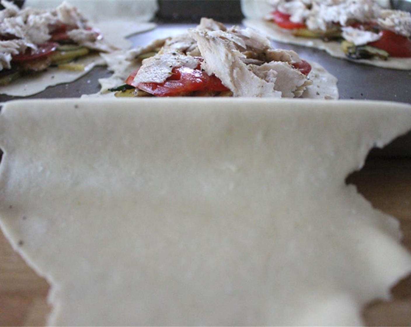 step 9 Divide potato mixture between the three crusts and spoon onto one side. Top with Tomato (1) and the fish. Sprinkle with a bit more salt, pepper, and fennel pollen.