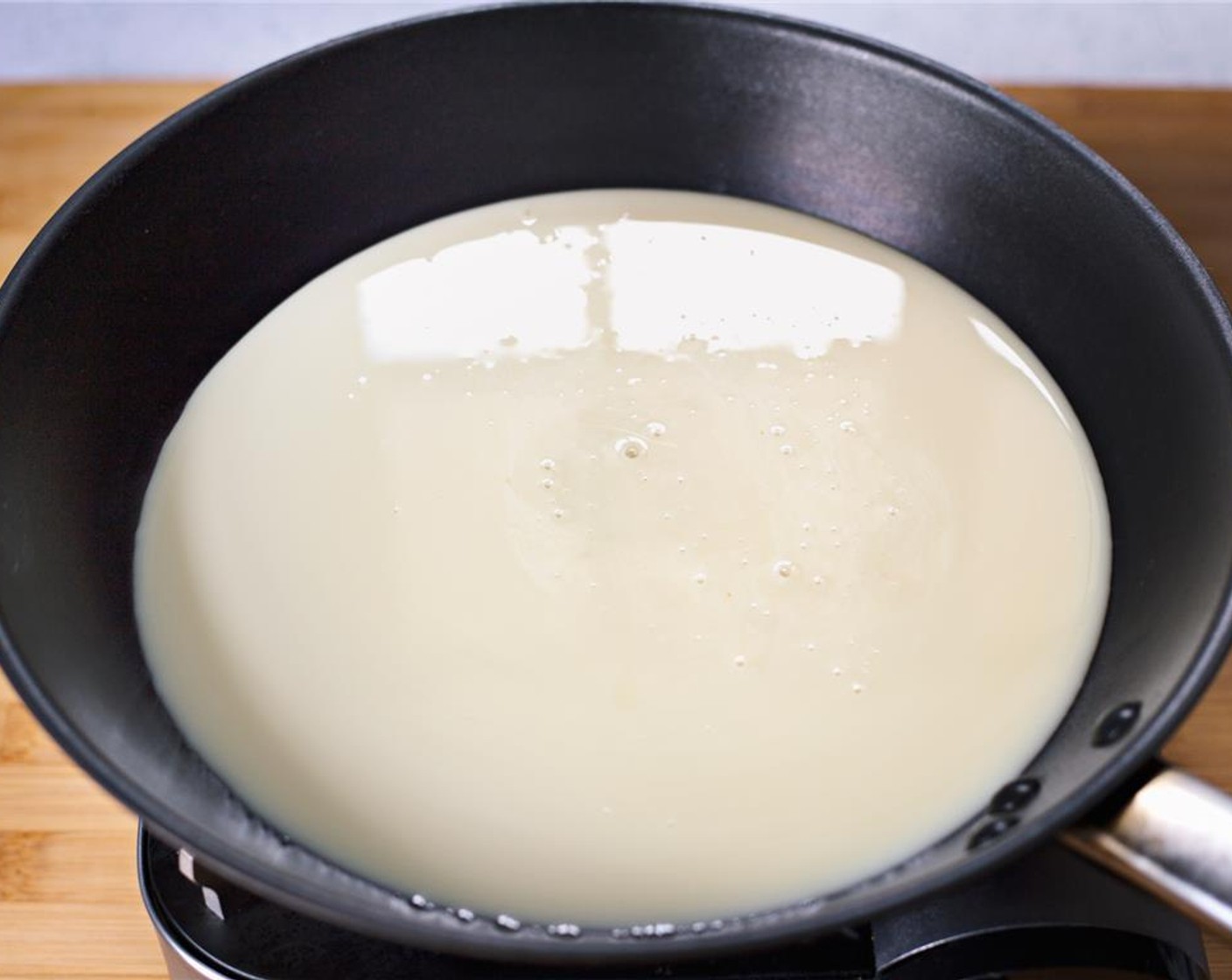 step 4 Make brigadeiros mixture by putting Sweetened Condensed Milk (1 cup) into a large saucepan over medium heat.