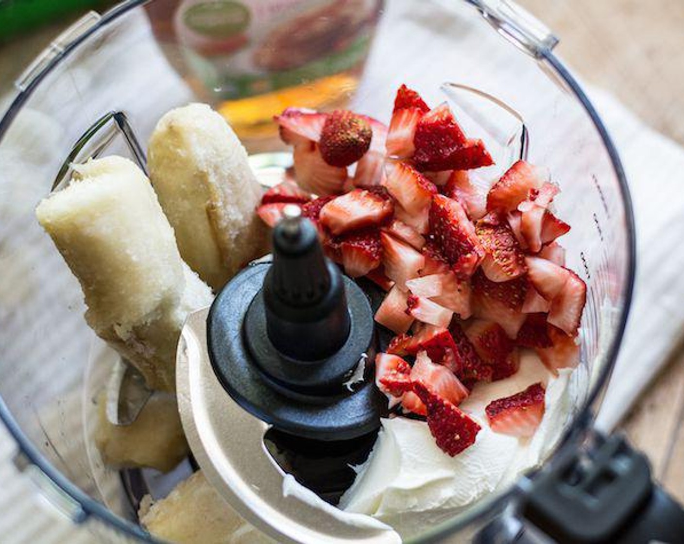 step 1 Add Fresh Strawberry (3/4 cup) to a bowl of a food processor, followed by Banana (1), Cream Cheese (1/2 cup), Maple Syrup (2 Tbsp), Whole Milk (1/4 cup), Organic Sweet Cream Coffee Creamer (1/4 cup) and the juice from Lemon (1).